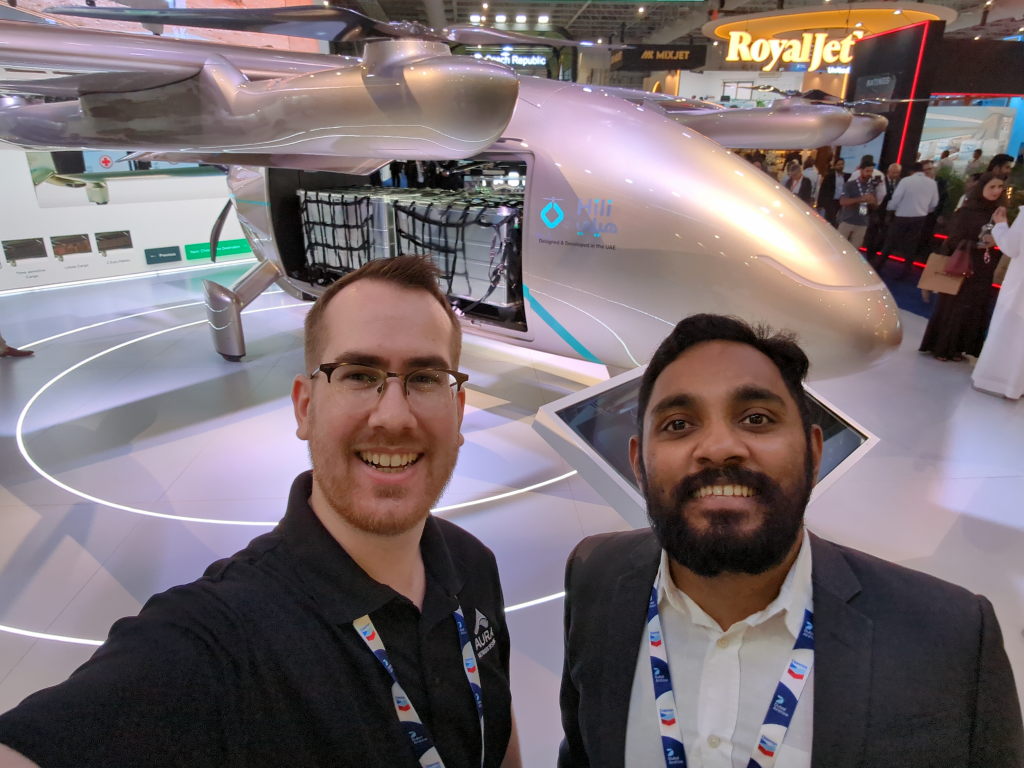 Max (left) and Vipin (right) stand in front of a VTOL cargo drone